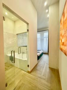 a bathroom with a tub and a sink and a bed at Logodi Apartment #castle #freeparking in Budapest