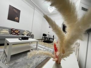 a person holding a bird in a living room at Beach view, Cozy 2BR apartment in Sharjah