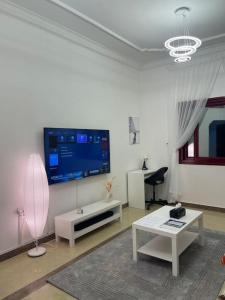 a living room with a flat screen tv on the wall at Beach view, Cozy 2BR apartment in Sharjah