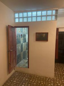 a room with a door and a mirror on a wall at EL GRAN TORIL in Taxco de Alarcón