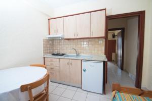 a small kitchen with a sink and a refrigerator at Villa Flegos in Skala Fourkas