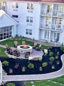 a backyard with a fire pit and chairs and a building at The Inn at Apple Valley, Ascend Hotel Collection in Pigeon Forge