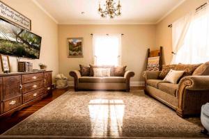 a living room with two couches and a tv at Maple Canyon*Pet-friendly fenced yard*RV Parking in Moroni