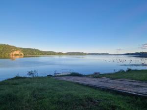 a view of a lake with a bench in the water at Ferienhaus in Paraguay, Encarnacion, 200 Meter vom Parana. in Encarnación