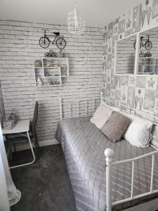 a bedroom with a bed and a bike on the wall at Rehoboth in Yew Gardens in Doncaster