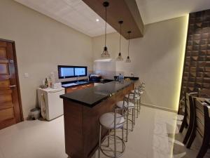 a kitchen with a counter and bar stools at Ferienhaus in Paraguay, Encarnacion, 200 Meter vom Parana. in Encarnación