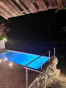 a swimming pool in a backyard at night at Hotel Azul Esmeralda in Teapa