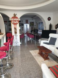 a living room with white furniture and red chairs at Design Apartments Tomelana in Ličko Petrovo Selo