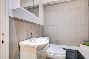 a bathroom with a sink and a toilet at Beautiful One Bedroom Apartment in Brentwood
