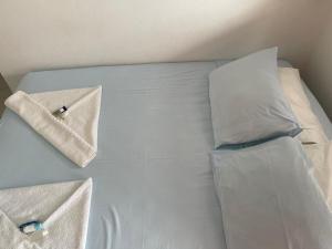 a bed with two pillows on it with at Pousada Canto Juquehy in Juquei