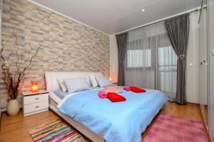 a bedroom with a large bed with a brick wall at Apartment Camelia in Poreč +101 photos