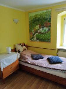 una camera da letto con un letto e un dipinto sul muro di "Agroturystyka pod Magnolią" Rybnica 33 a Rybnica