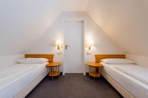 Postel nebo postele na pokoji v ubytování Hotel Leuchtfeuer