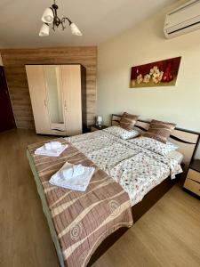 a bedroom with a large bed with towels on it at The View in Sandanski