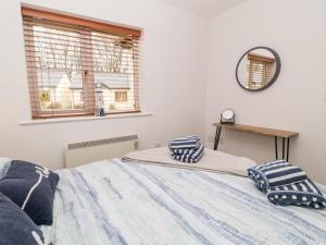 a bedroom with a bed with pillows on it at Lilyvale in Camelford