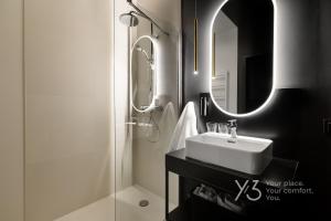 a bathroom with a sink and a shower and a mirror at Saint Martin Residence Old Town with Wellness in Poznań