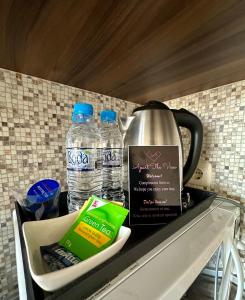 a tea kettle and two bottles of water on a counter at The View in Sandanski