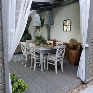 a white table and chairs on a patio at Siedlisko Gruszki Puszcza Białowieska in Narewka