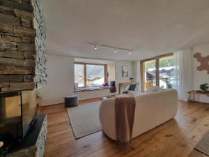 a living room with a couch and a fireplace at Riverside 2nd Floor North in Saas-Fee