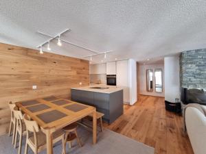 a kitchen and dining room with a table in a room at Riverside 2nd Floor North in Saas-Fee