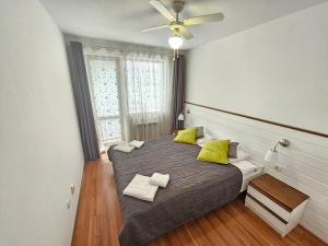 a bedroom with a bed with two pillows on it at Bansko Private VIP Apartment in Bansko +35 photos