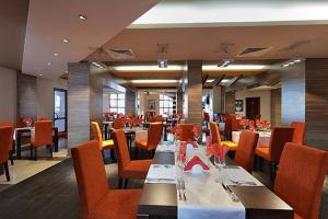 a restaurant with tables and chairs in a room at Bansko Private VIP Apartment in Bansko