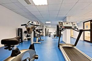 a gym with treadmills and machines in a room at Bansko Private VIP Apartment in Bansko