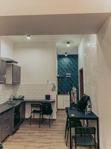 a kitchen with chairs and a table in a room at SZONDI Heroes Square in Budapest