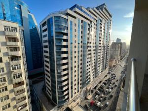 an aerial view of a tall building in a city at Park Azure 11054 in Baku