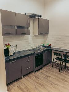 a kitchen with a sink and a stove top oven at SZONDI Heroes Square in Budapest