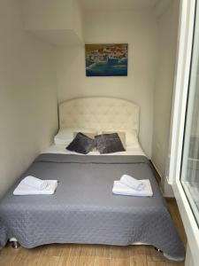 a bedroom with a bed with two towels on it at Apartment Matea in Dubrovnik