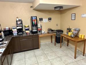 a kitchen with a counter and a counter top at Days Inn & Suites by Wyndham Pigeon Forge in Pigeon Forge