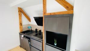 a small kitchen with a sink and a stove at Heimatliebe Erfweiler Wohnung DREI in Erfweiler