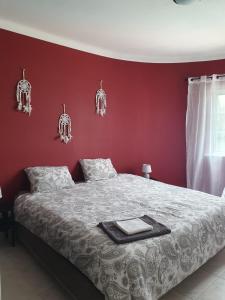 a bedroom with a bed with a red wall at Brisa's Haven Guesthouse !Pet Friendly! in Lagos