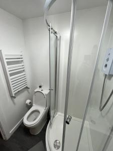 a bathroom with a toilet and a shower at west walk house in Nottingham