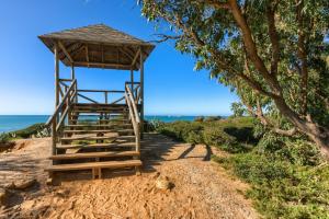 a wooden lifeguard tower on a beach with the ocean at MARIA DEL MAR SEA APARTMENT in Chiclana de la Frontera