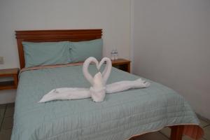 Postel nebo postele na pokoji v ubytování Orquídeas Hotel