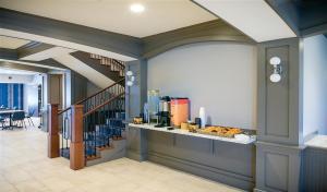 a restaurant with a counter with food on it at Winds Hotel at Crosswinds Casino in Park City +19 photos