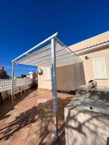 a metal canopy on top of a patio at La Paranza Apartments Lampedusa in Lampedusa