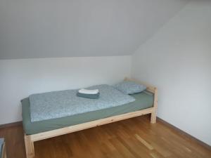 a small bed in a room with a white wall at Apartments Captain Morgan Prague in Prague