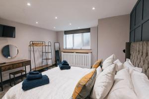 una camera da letto con un grande letto con asciugamani blu di GROVE HOUSE NO.07 - Luxury Apartment close to the Llandudno Beach a Llandudno