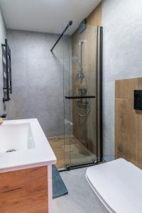 a bathroom with a shower and a sink and a sink at Apartamenty Pod Wyciągiem in Wisła