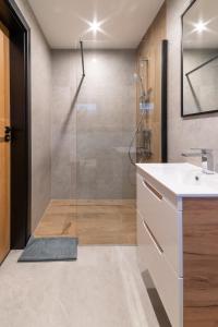 a bathroom with a glass shower and a sink at Apartamenty Pod Wyciągiem in Wisła +21 photos