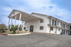a white building with a parking lot in front of it at Salt Creek Lodge in Graham +33 photos
