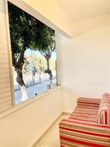 Rambam BEACH apartment في حيفا: غرفة معيشة مع أريكة ونافذة