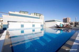 a swimming pool in front of a building at Sliema Tigne Suites in Sliema