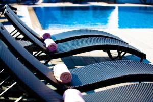 a pair of benches with skateboards on them near a pool at Sliema Tigne Suites in Sliema