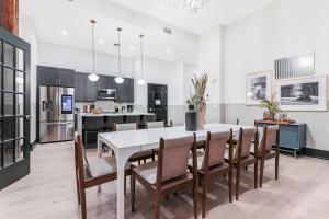 a kitchen and dining room with a white table and chairs at Roami at The Lola in New Orleans