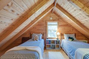two beds in the attic of a log cabin at Maine Lodging Near Acadia National Park! in Bernard
