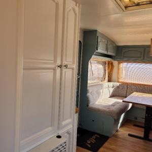 an interior view of an rv with a door and a table at Przyczepa Kempingowa Zefirek in Jastarnia